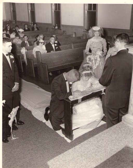 Dad and Mom praying at the altar during their wedding on December 6, 1956.  